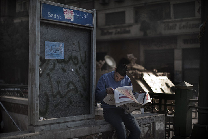 egypt day 21: An Egyptian man reads a newspaper