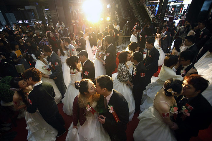 Valentine's Day: Taipei, Taiwan: Couples kiss during a mass wedding ceremony 