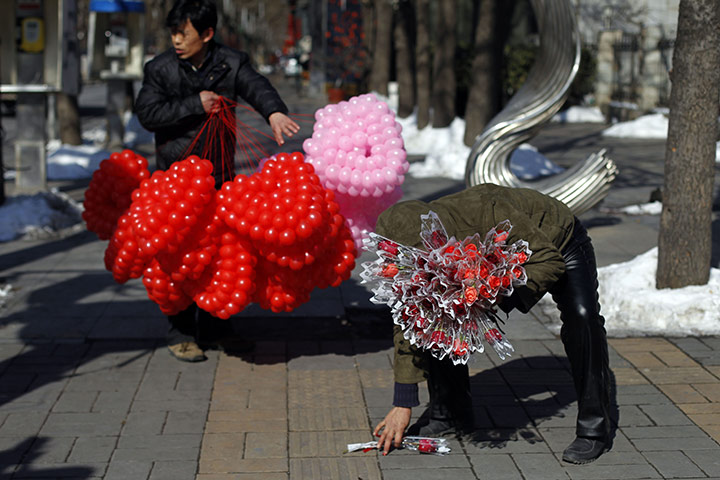 Valentine's Day: Beijing, China: A vendor selling roses and another selling balloons 