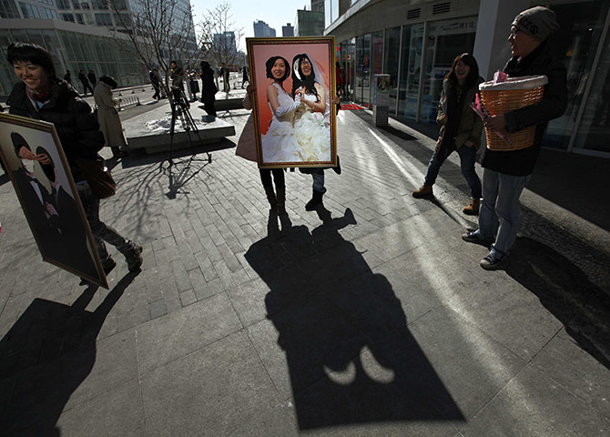 Valentine's Day: Beijing, China: Women pose for photographs with a picture board