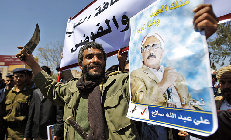 Arab unrest: government supporter waves a dagger  in Yemen