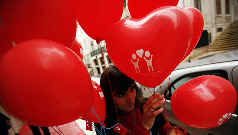 Valentine's Celebrations: A woman holds Valentine's Day balloons in Lisbon
