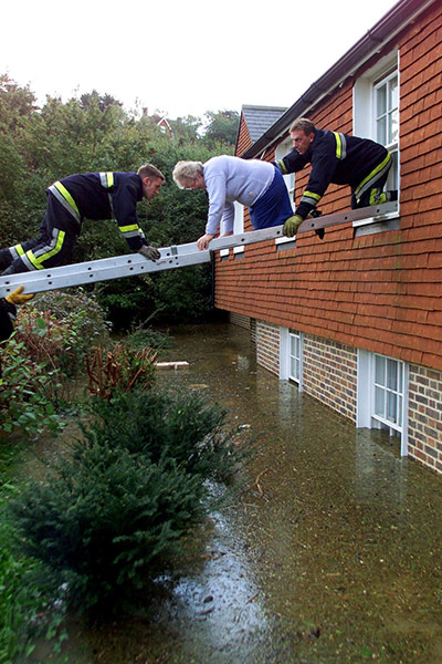 Floods 2000: FIREMEN RESCUE AN ELDERLY WOMAN FROM HER HOME IN LEWES