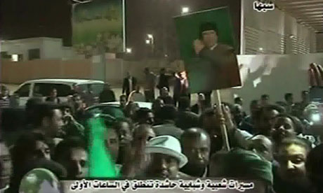 Footage broadcast by Libya's state television showing Libyans holding portraits of Muammar Gaddafi