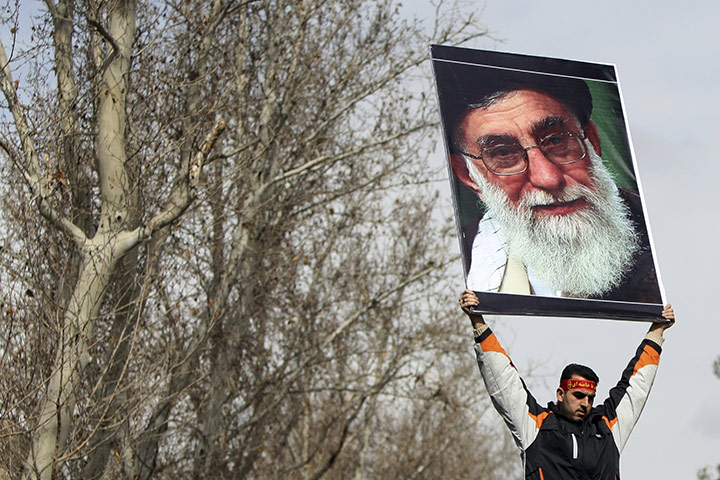 Protests spread: Tehran, Iran: A pro-government man holds a poster of Ayatollah Ali Khamenei