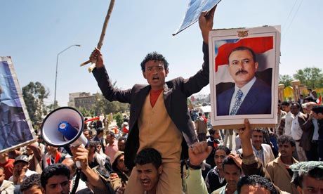 Supporters of the Yemeni government shout slogans as they try to enter Sana'a University