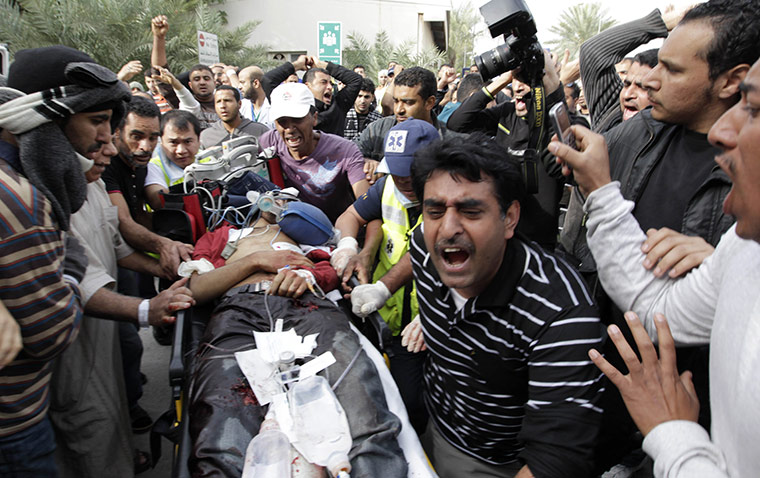bahrain: A Bahraini anti-government demonstrator lies injured 