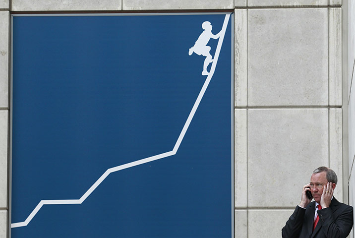 Week in Business: A man speaks on his mobile phone in the Canary Wharf financial district 