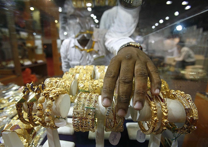 Week in Business: A salesman arranges gold bangles at a jewellery exhibition in Kolkata