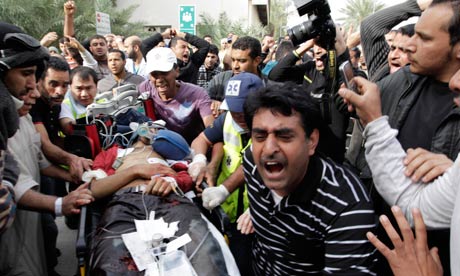 Bahraini demonstrator lies injured on a stretcher