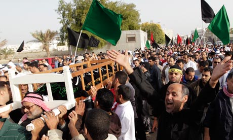 Bahrani anti-goverment protesters carry coffin of Ali Massour Khodier, in Sitra village, Bahrain