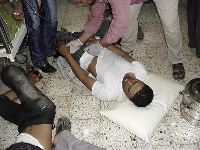 Yemen Protests: A medic attends to an anti-government protester who was injured