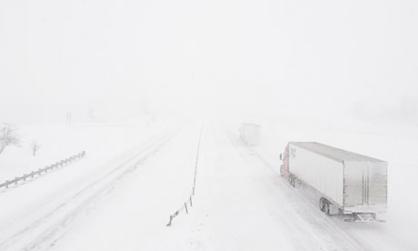 Lorries struggle through whiteout conditions on the I-70 highway in Missouri
