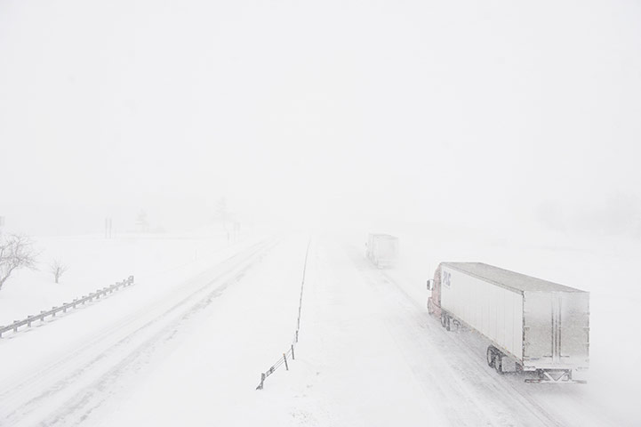 US White Out: Trucks disappear into the white snow