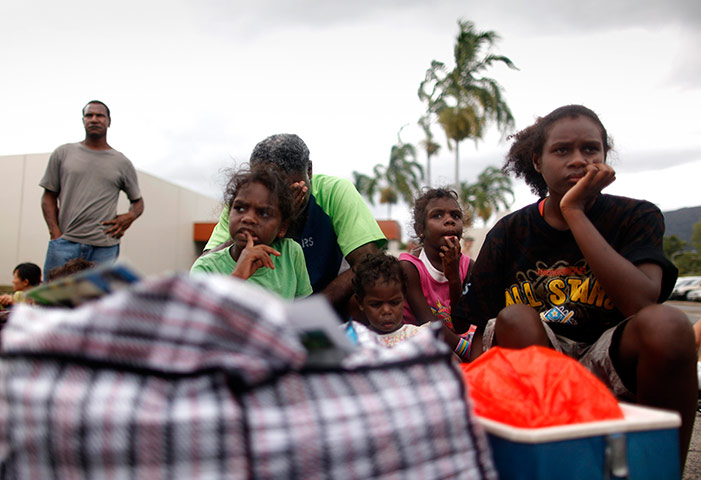 Cyclone Yasi preparations: Family wait outside an emergency cyclone shelter in Cairns