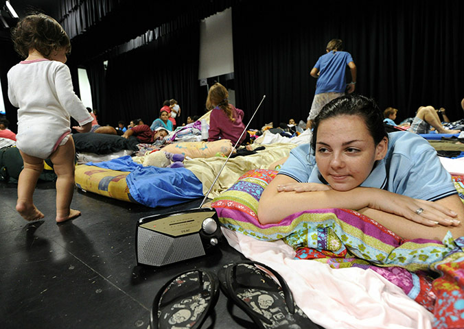 Cyclone Yasi preparations: Woman listens to weather updates at an emergency evacuation centre