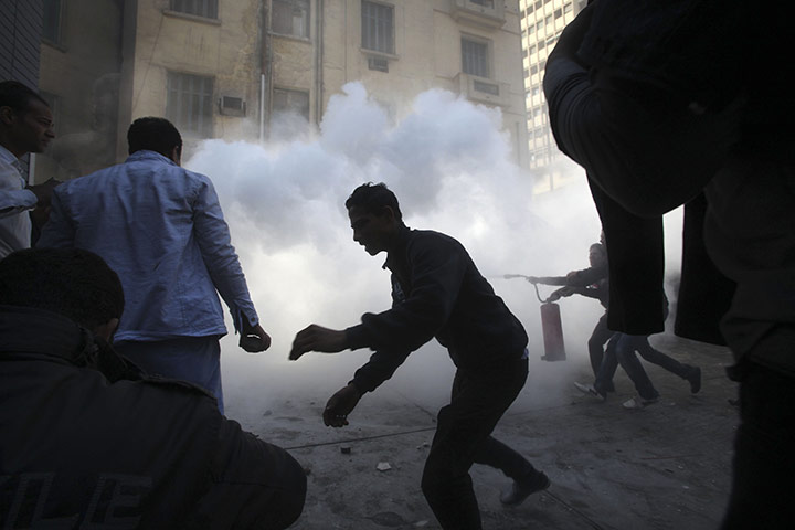 Clashes in Egypt day 9: Demonstrators run for cover during rioting between  in Tahrir Square 