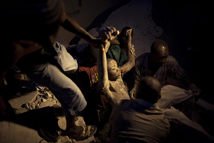 24 hours in pictures: earthquake-damaged house collapses in Port-au Prince, Haiti