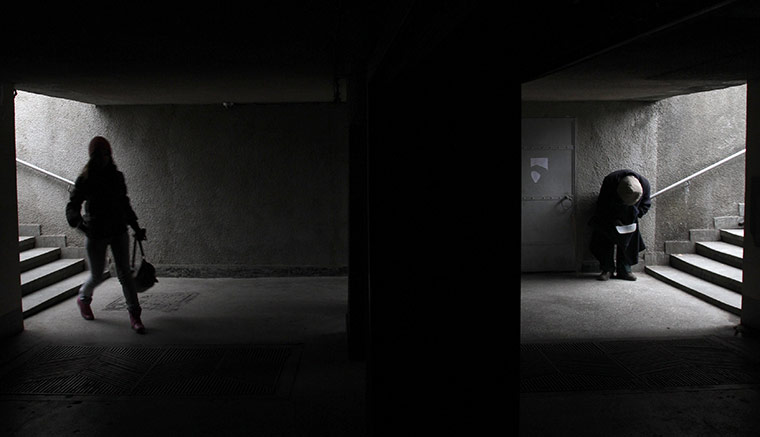 24 hours in pictures: A woman walks near a beggar in the subway in Tbilisi