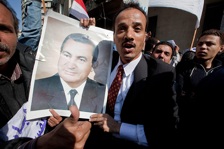 Sean Smith in Cairo: A man holds a photograph of President Hosni Mubarak