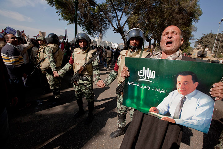 Sean Smith in Cairo: A man holds a photograph of President Hosni Mubarak