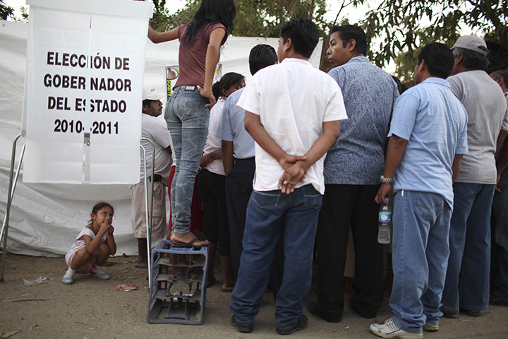 FTA Alexandre Meneghini: A child watches as election commission employees count ballots 