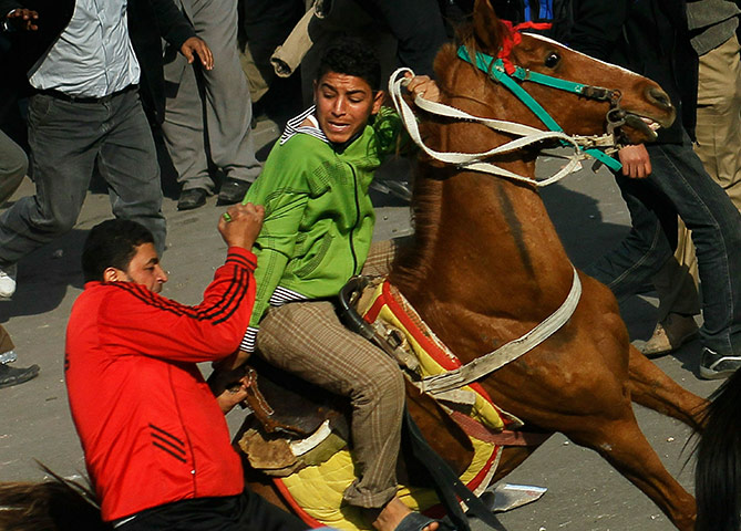 Battle for Egypt: Demonstrators for and against the government clash in Cairo