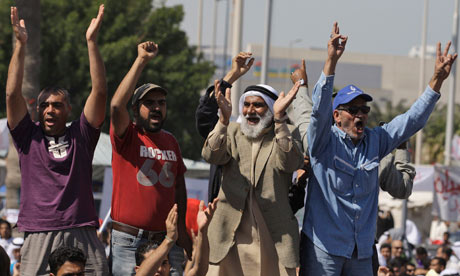 Bahraini anti-government protesters chant slogans at the Pearl roundabout in Manama, Bahrain