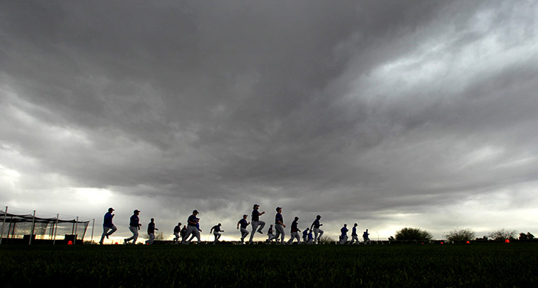 24 hours: Surprise, Arizona, USA: Texas Rangers players in an approaching storm cloud