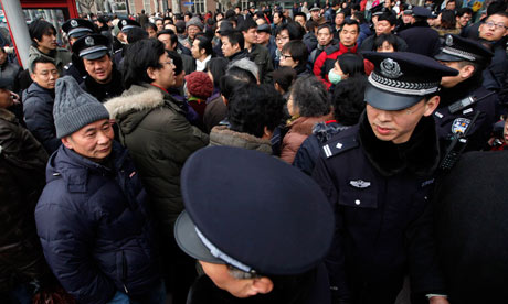 Police on the streets of Shanghai after an online call for demonstration sparked a crackdown