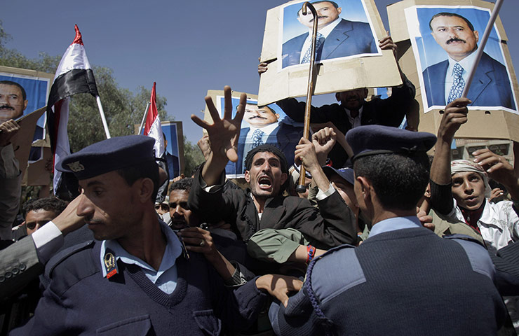 Arab protests: Sana'a, Yemen: Yemeni policemen push back government supporters