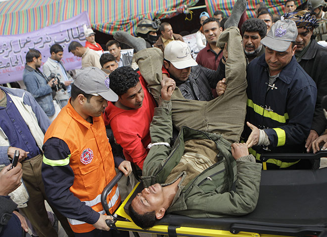 Arab protests: Baghdad, Iraq: An anti-Iraqi government protester is taken to hospital