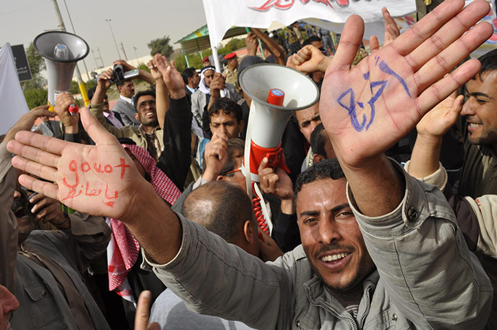 Arab protests: Ramadi, Iraq: An Iraqi man shows writing on his palms saying 