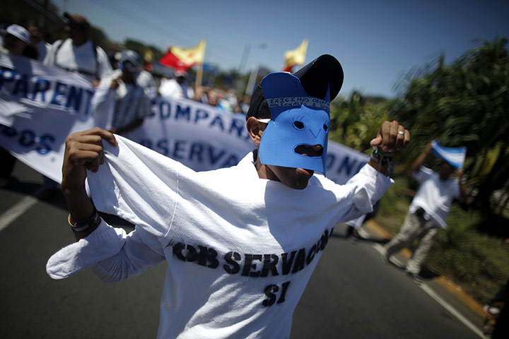 24 hours:  Managua, Nicaragua: A man wears a mask during a demonstration 