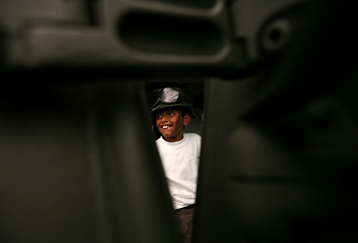 24 hours: Mexico City, Mexico: A young boy plays inside an armoured vehicle 