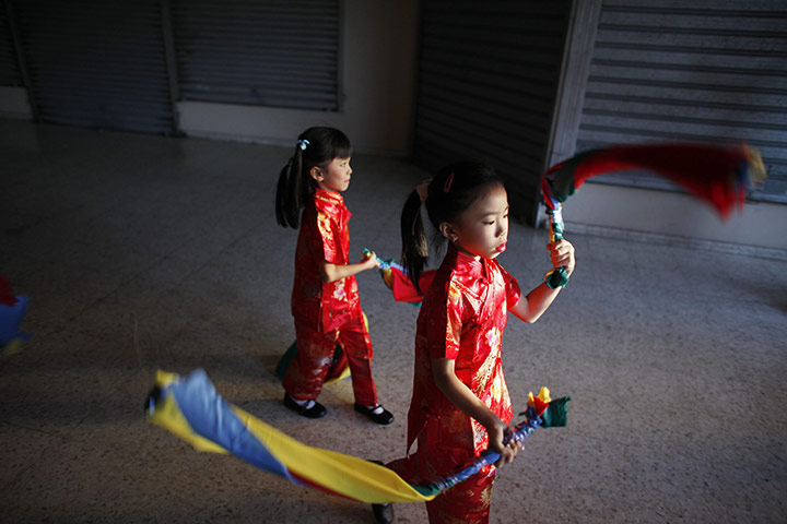 24 hours: Santo Domingo, Dominican Republic: Chinese girls practice for a performance