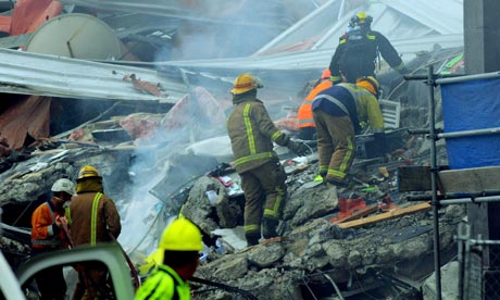 Rescuers climb across rubble in Christchurch