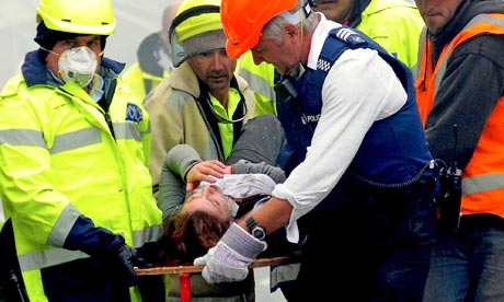 An injured person is carried by rescue workers after an earthquake hit Christchurch, New Zealand