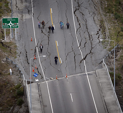 New Zealand aftermath: People walking over the South Brighton bridge, Christchurch