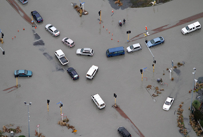 New Zealand aftermath: Cars are abandoned on a flooded street, Christchurch