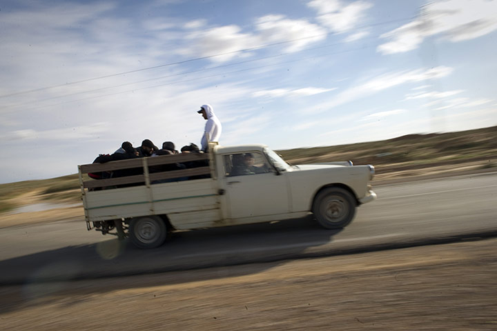 Libya unrest: Tunisians in Libya travel by pickup truck, en route to the Ras Jdir border