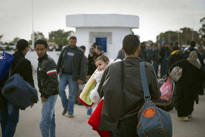 Libya unrest: Tunisians working and living in Libya gather at the Rad Jdir border