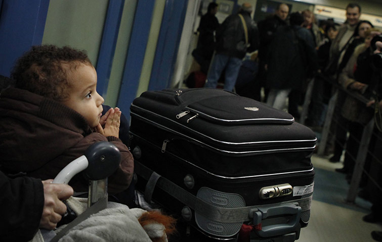Libya unrest: A young Bulgarian child arrives with his parents at Sofia airport