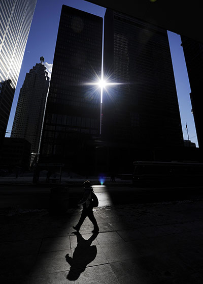 24 hours in pictures: A woman walks in the financial district of Toronto