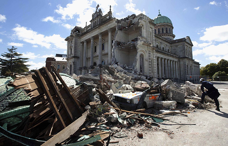 Christchurch earthquake: A rescue worker looks at the rubble of the Cathedral of Blessed Sacrament