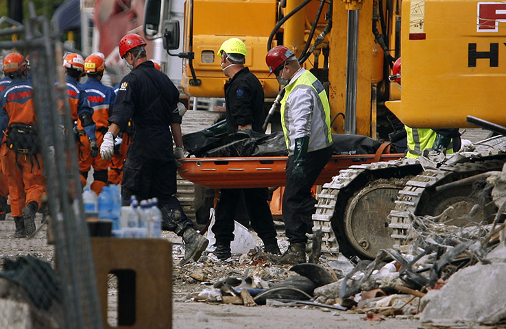 Christchurch earthquake: Emergency services remove a body from the destroyed CTV building 