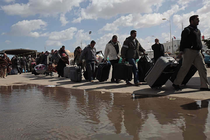 Libya 25: People carry their belongings after they fled Libya