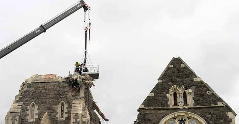 New Zealand Quake: Recovery workers lowered by a crane onto the top of Christchurch Cathedral