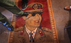 libya update 2: Libyans step on a carpet featuring Libyan leader Gaddafi in Benghazi