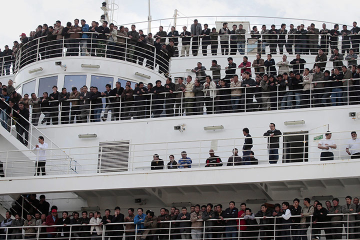 Libya 26 Feb: Chinese citizens, evacuated from Libya, wait aboard a ferry in Valletta